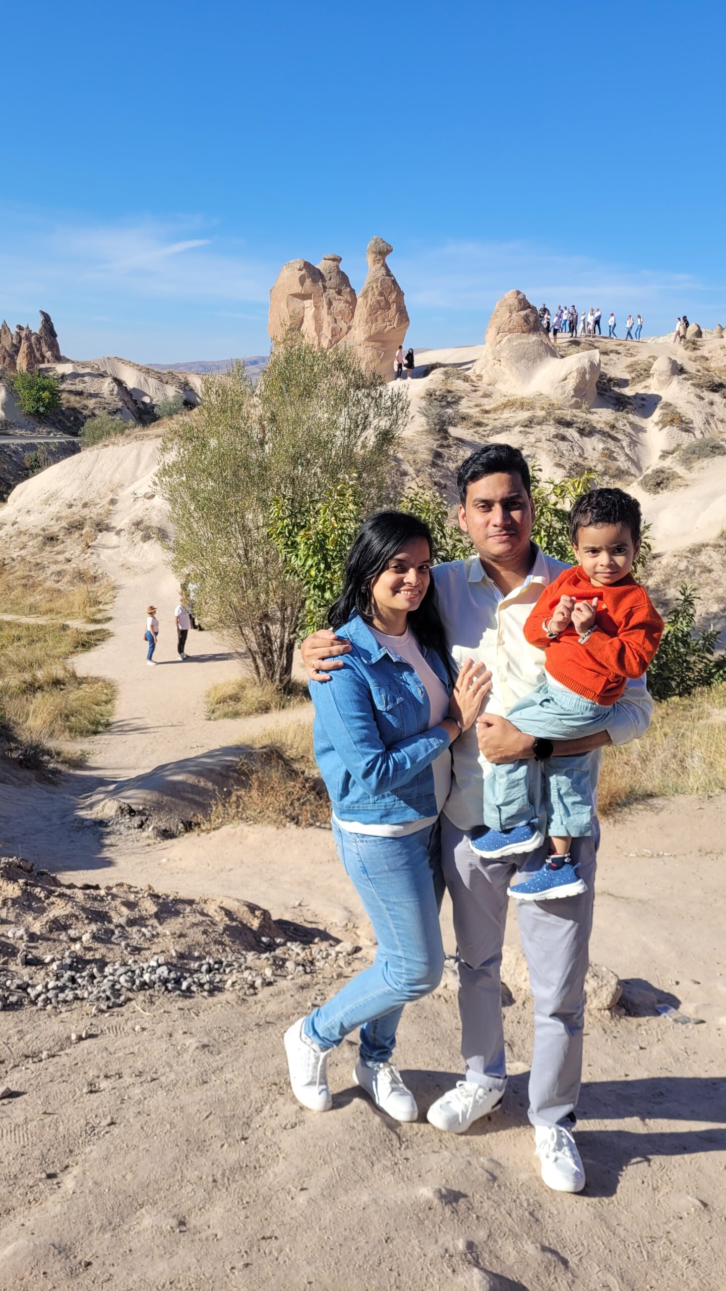 Family in Cappadocia, Turkey — fairy chimneys in the background